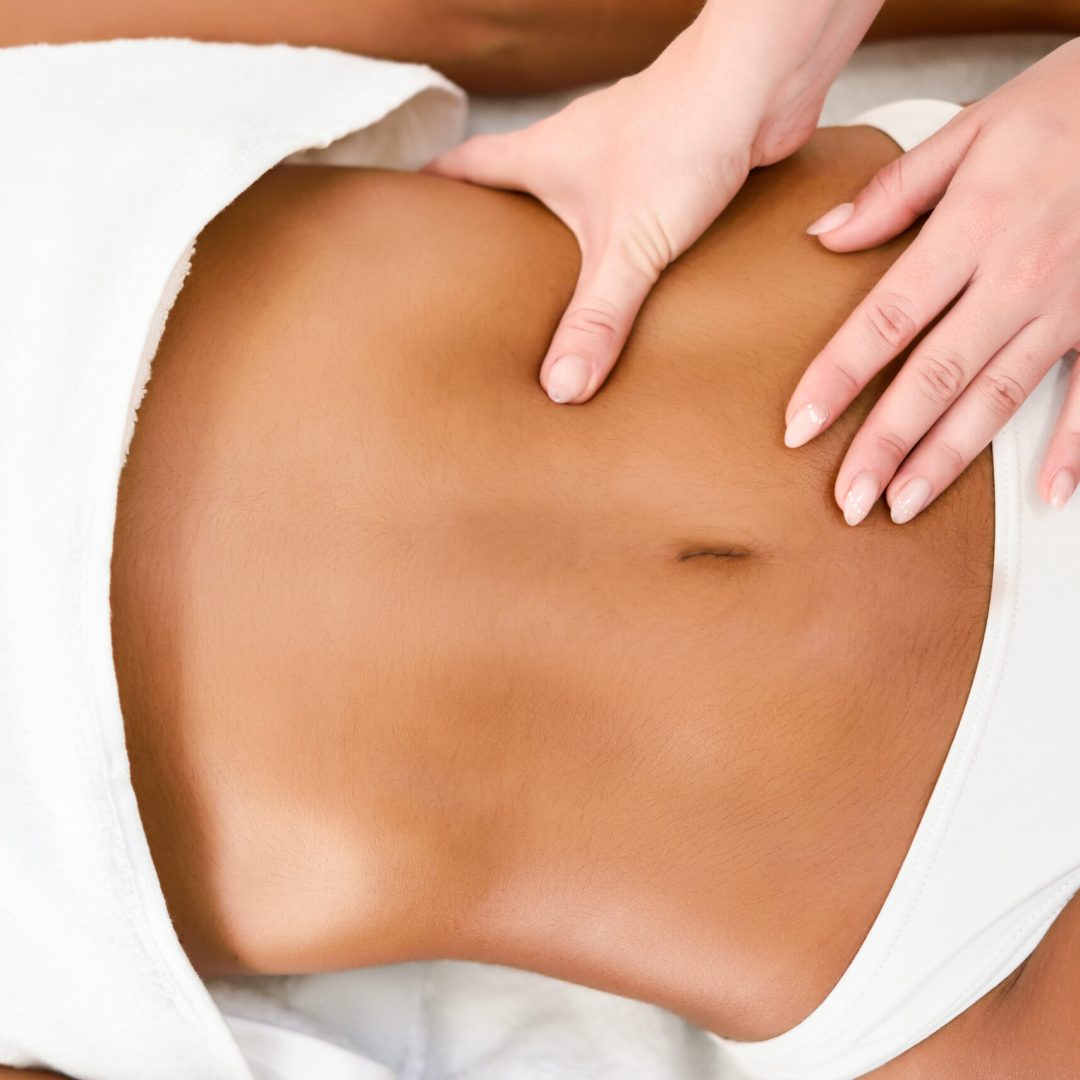 Woman receiving abdomen massage in spa wellness center. Beauty and Aesthetic concepts.